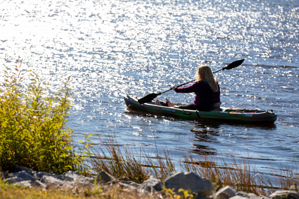 Prince Edward County woman boating on Sandy River